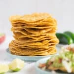 Tostada shells stacked on a plate.