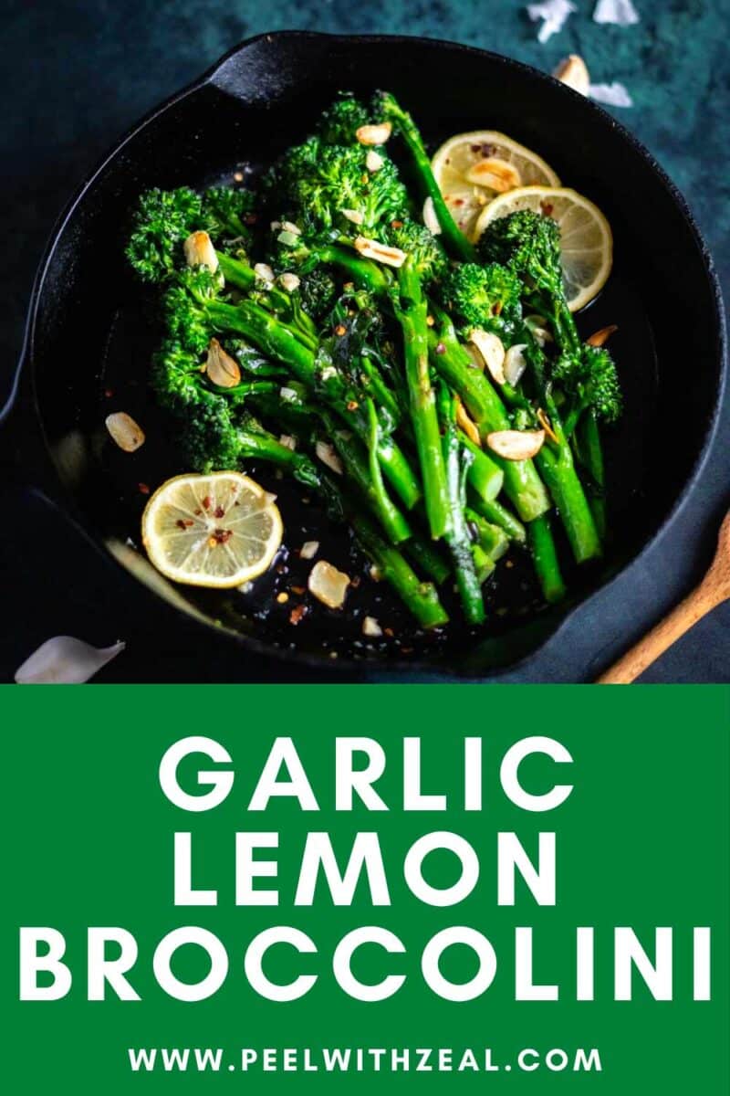 Broccolini in a cast iron pan with lemon slices and garlic.