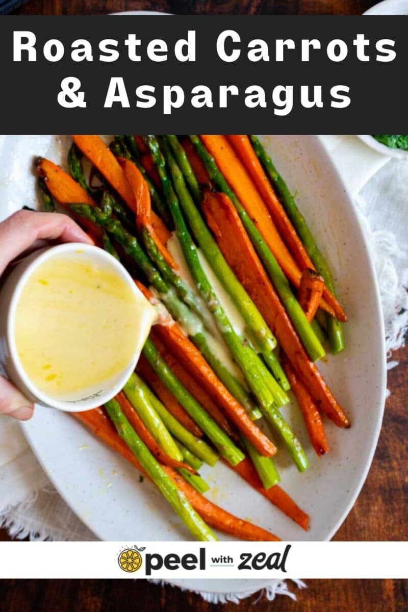 Pouring sauce on carrots and asparagus.