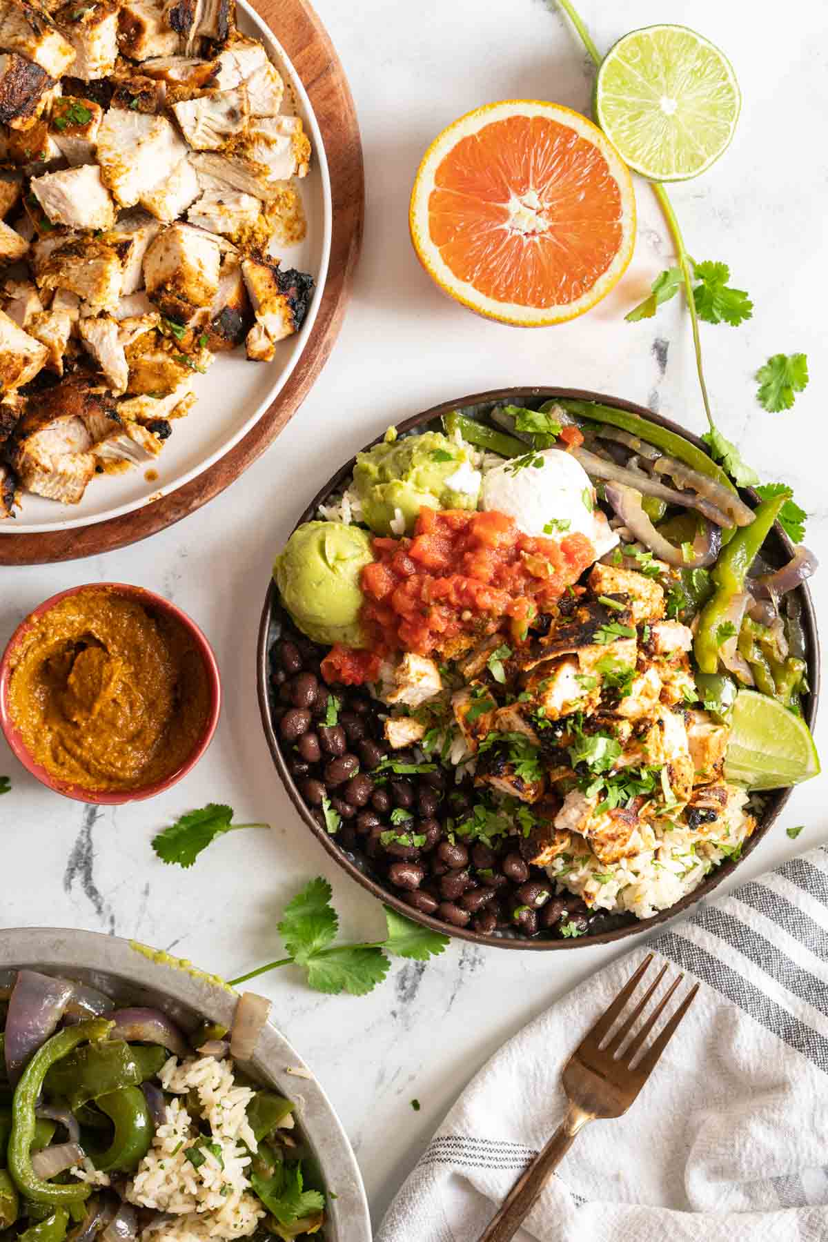 Chipotle style bowl with rice, chicken and fajita peppers.