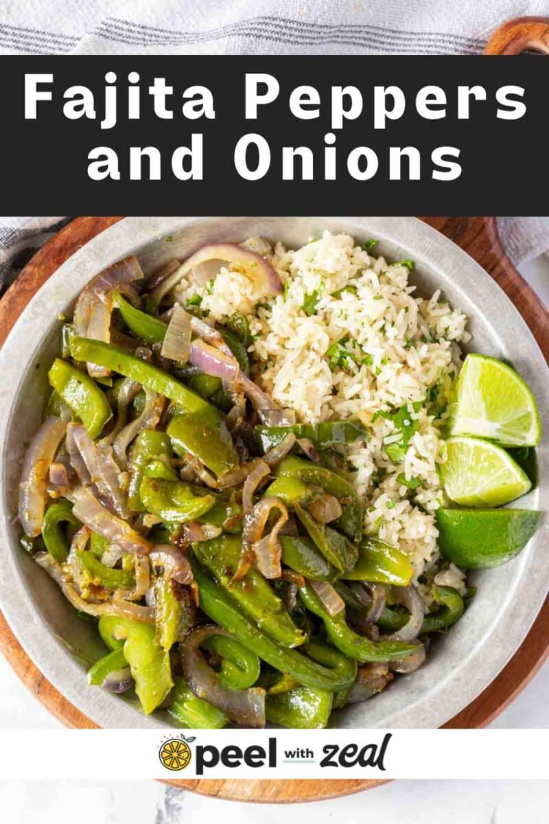 Green peppers and onions with rice and lime wedges.