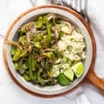Green peppers and onions with rice, limes, and cilantro.