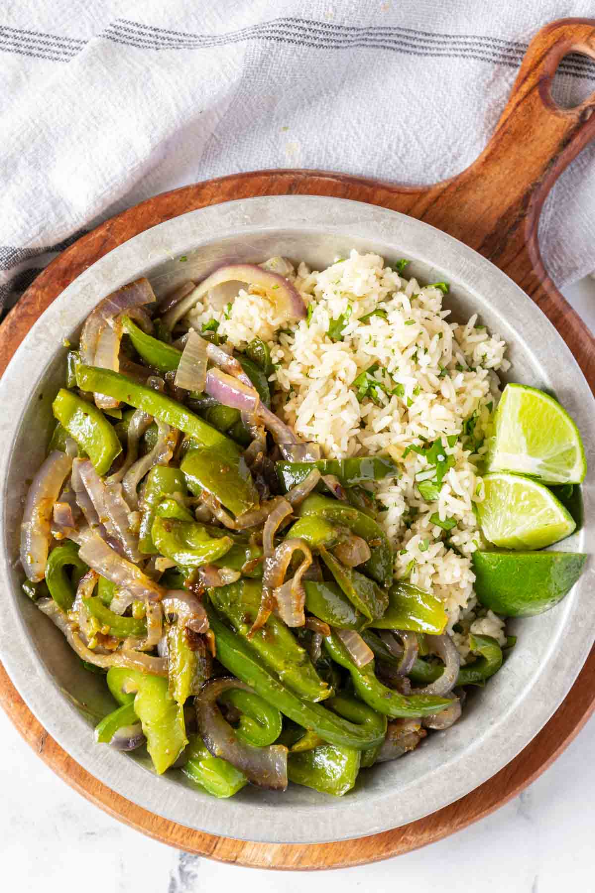 Green peppers and onions with rice, limes, and cilantro.