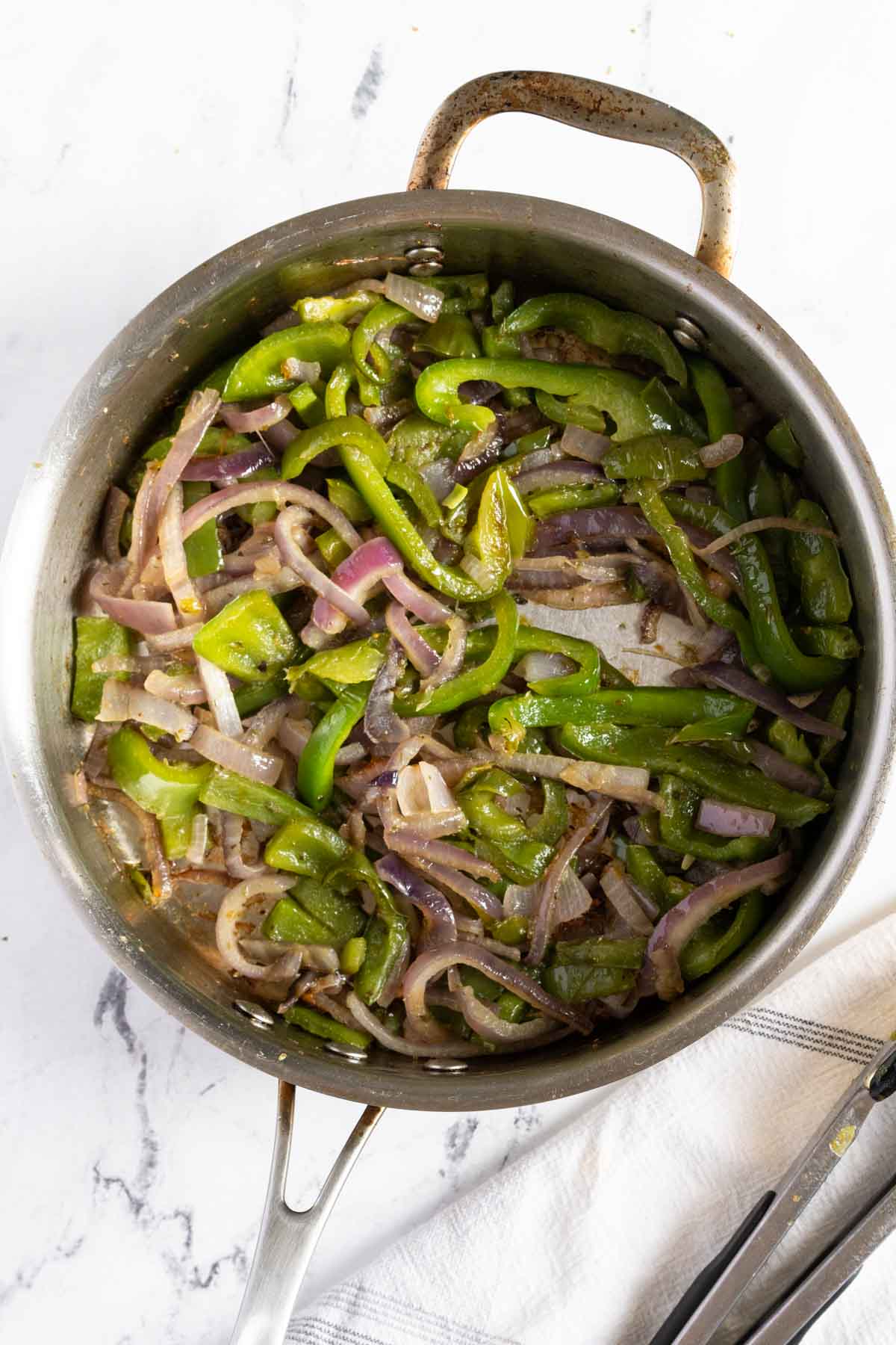 Sauteed pepper and onions in a pan.
