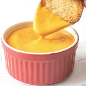 Dipping bread into cheese sauce.