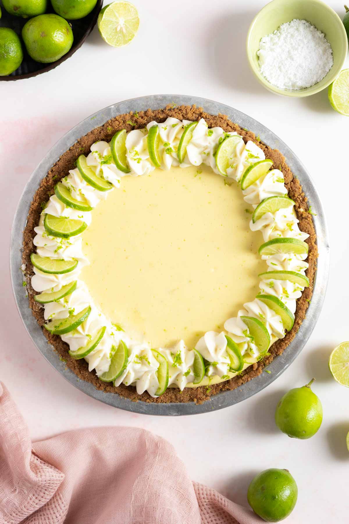 Key lime pie with whipped topping and lime slices.