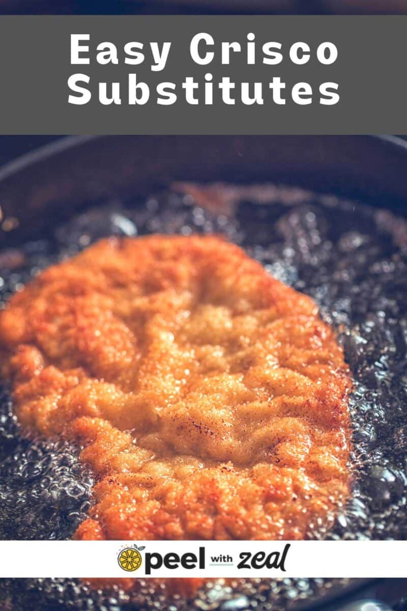 Deep frying chicken in oil.