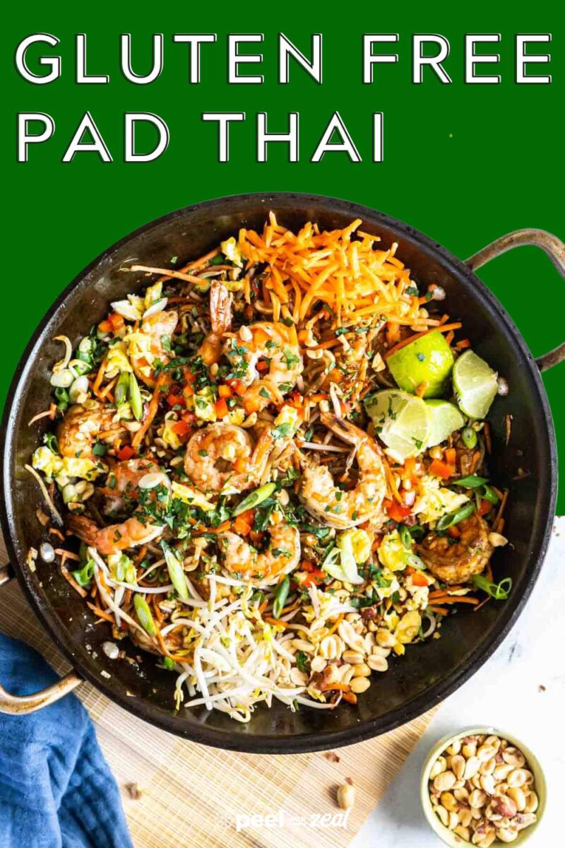 Pad thai in a pan on a bamboo placemat.