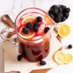 Pitcher of berrt lemonade on counter.