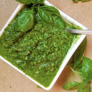 Basil pesto in bowl with spoon.
