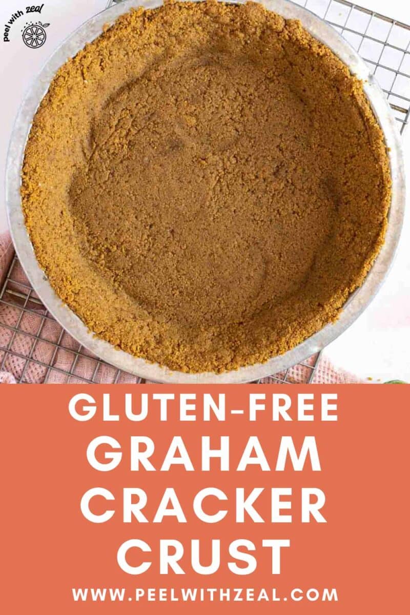 Graham cracker pie crust in a pan on a cooling rack.