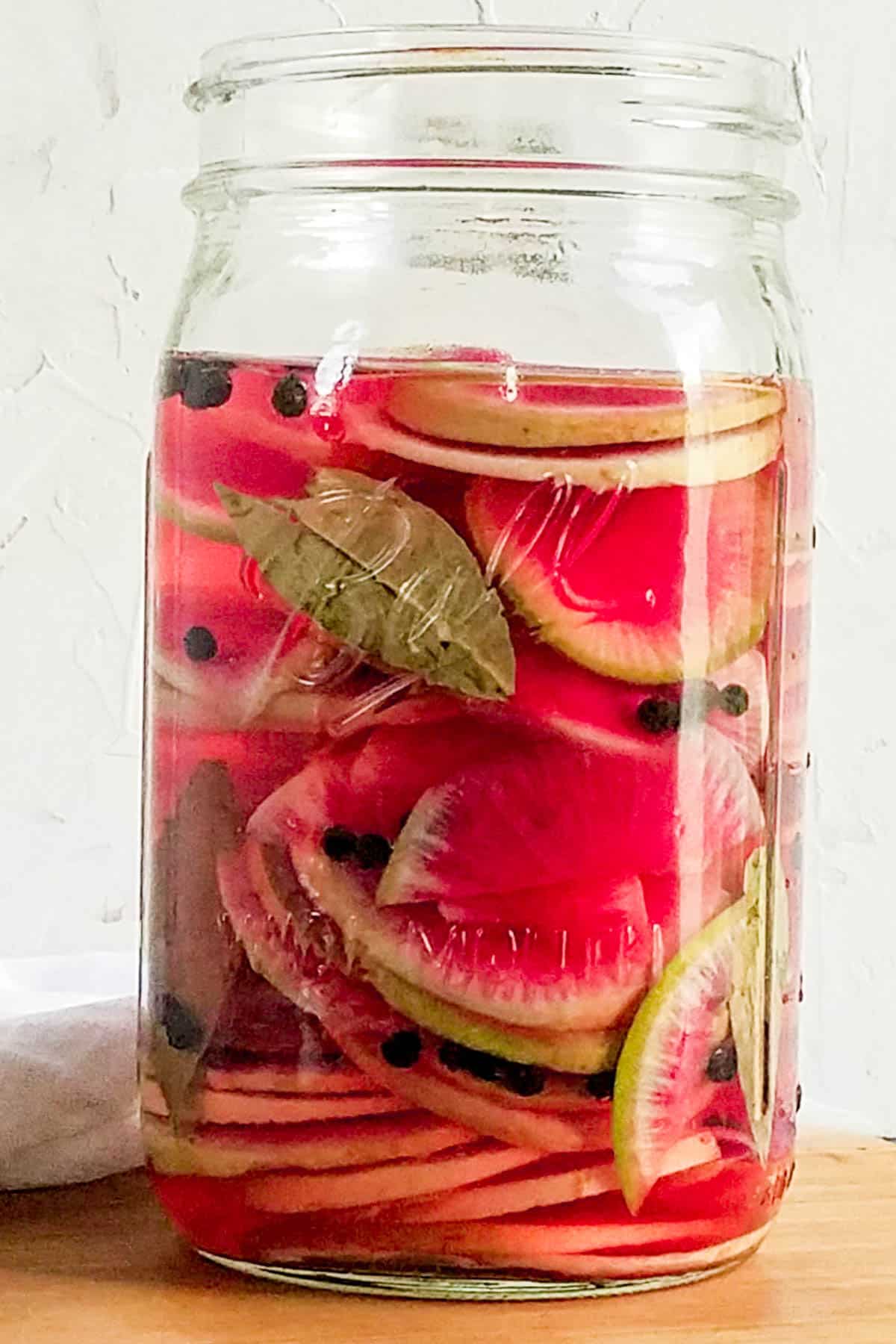 Watermelon radish pickles in a jar.