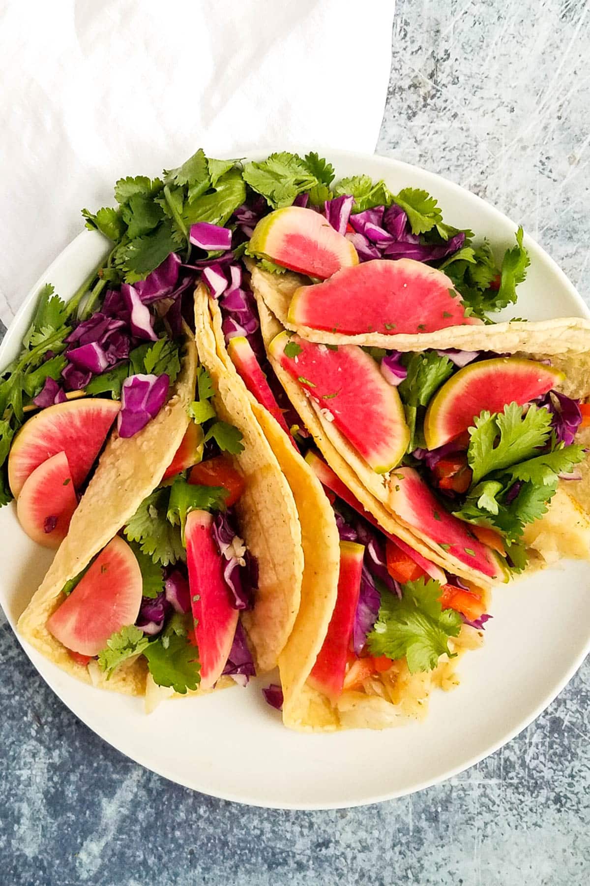 Tacos with pickles radishes.