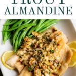Trout with a brown butter almond sauce on a plate.
