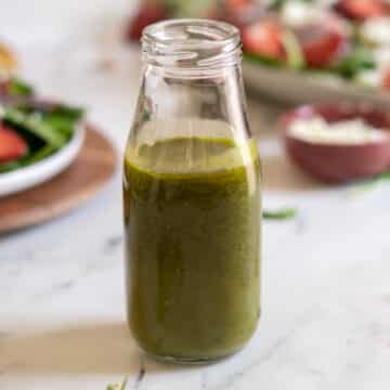 Homemade fresh basil salad dressing in a bottle.