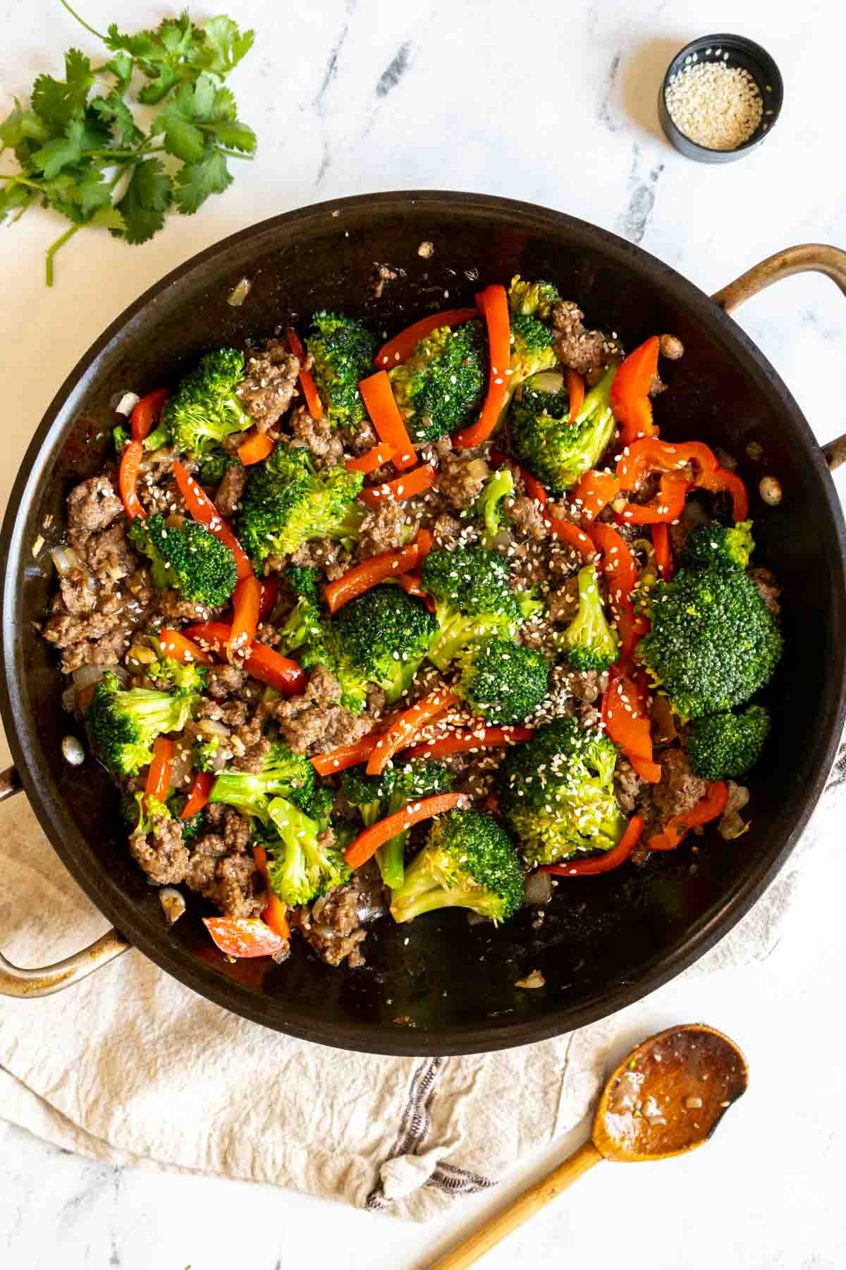 Sauteed vegetables and ground beef in a pan.