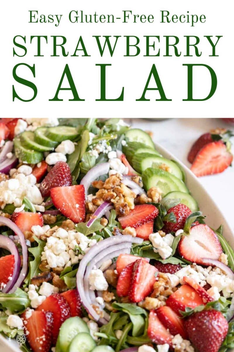 Strawberry and goat cheese on a salad with cucumber.