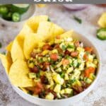 Pineapple salsa in a bowl with tortilla chips.