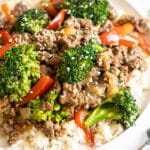 Beef and broccoli with red peppers over rice.