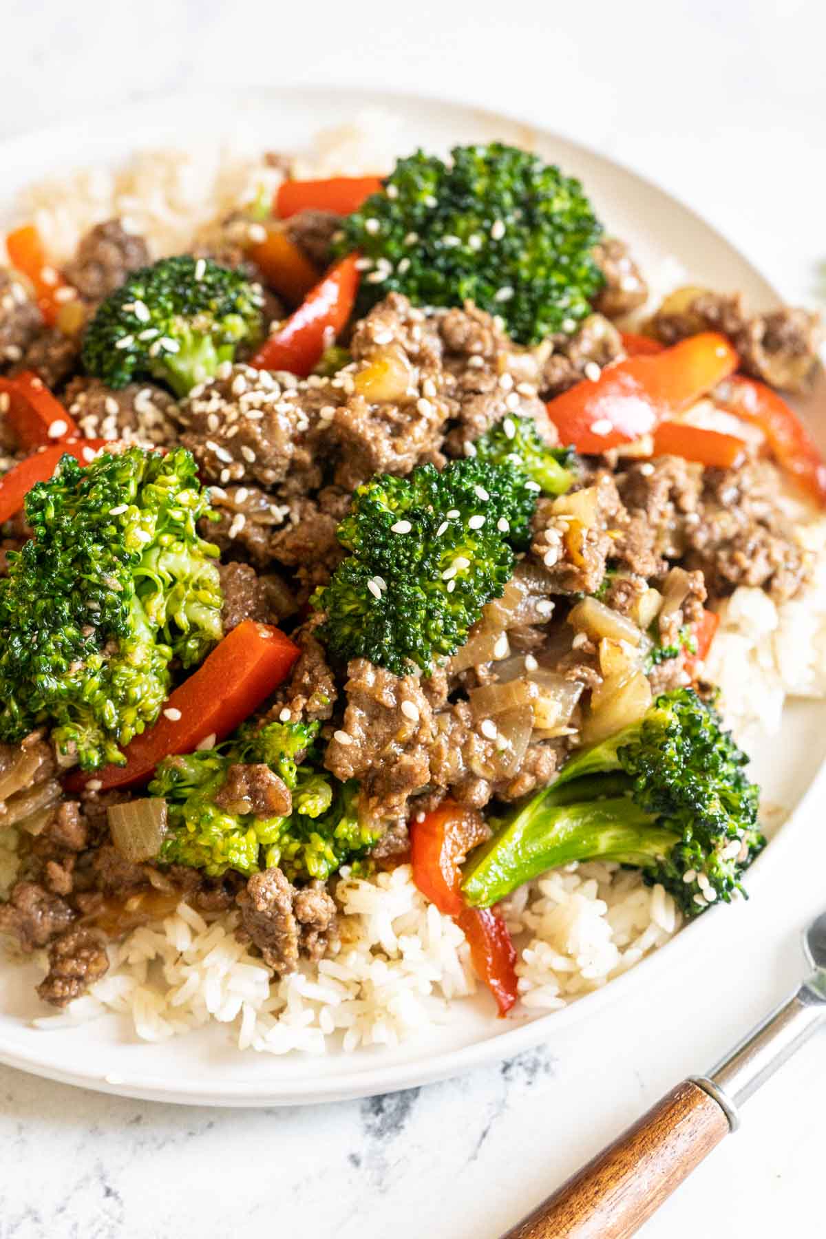 Beef and broccoli with red peppers over rice.