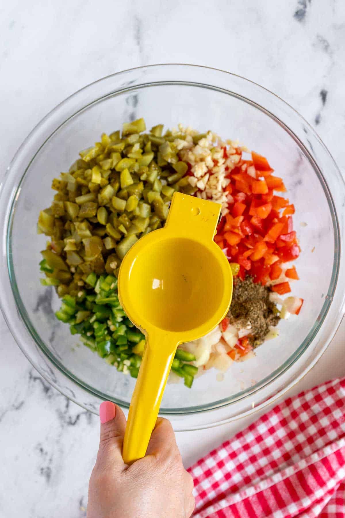 Juicer over bowl of salsa.