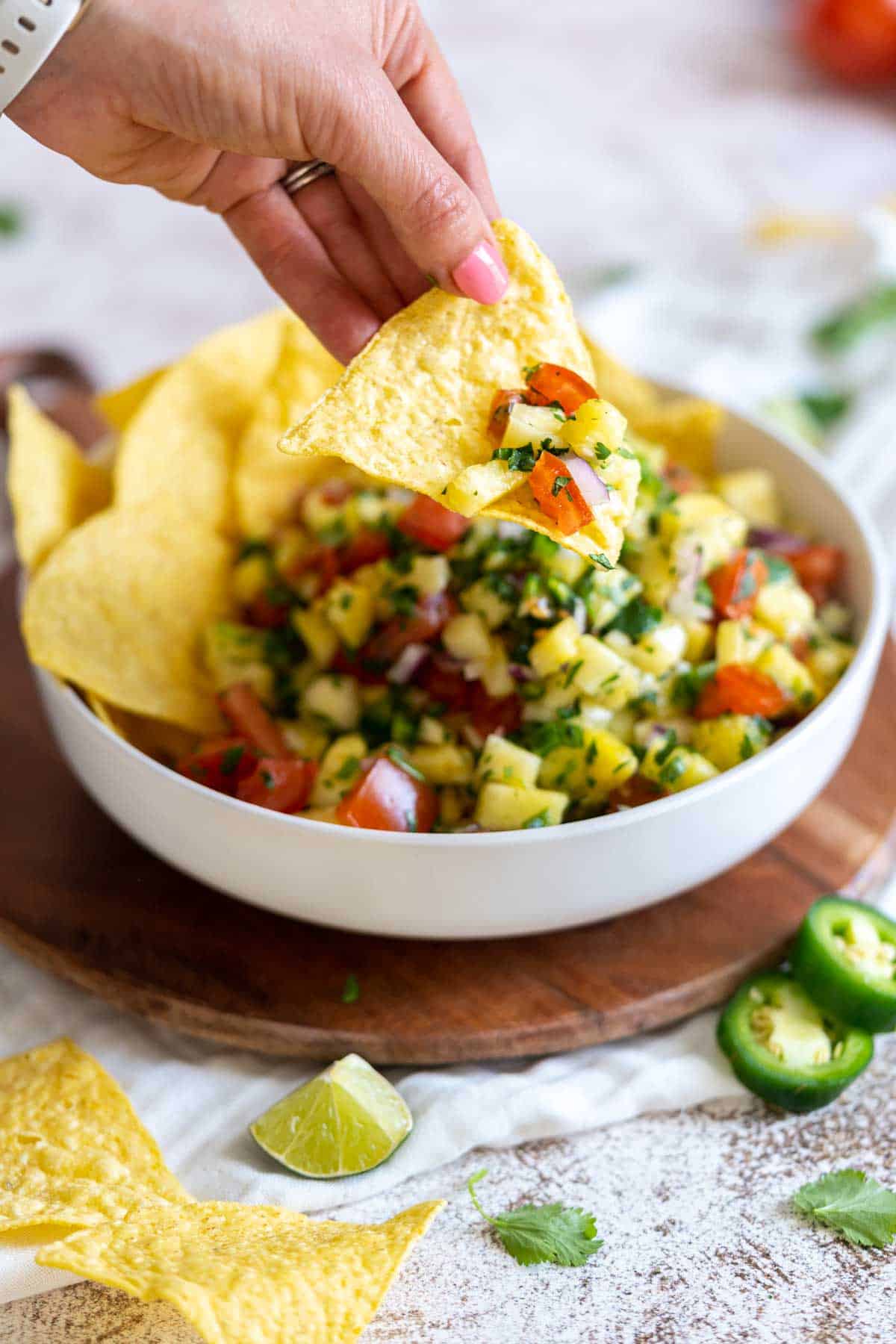 Dipping a chip into salsa.