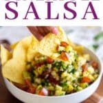 Pineapple pico de gallo in a bowl with tortilla chips.