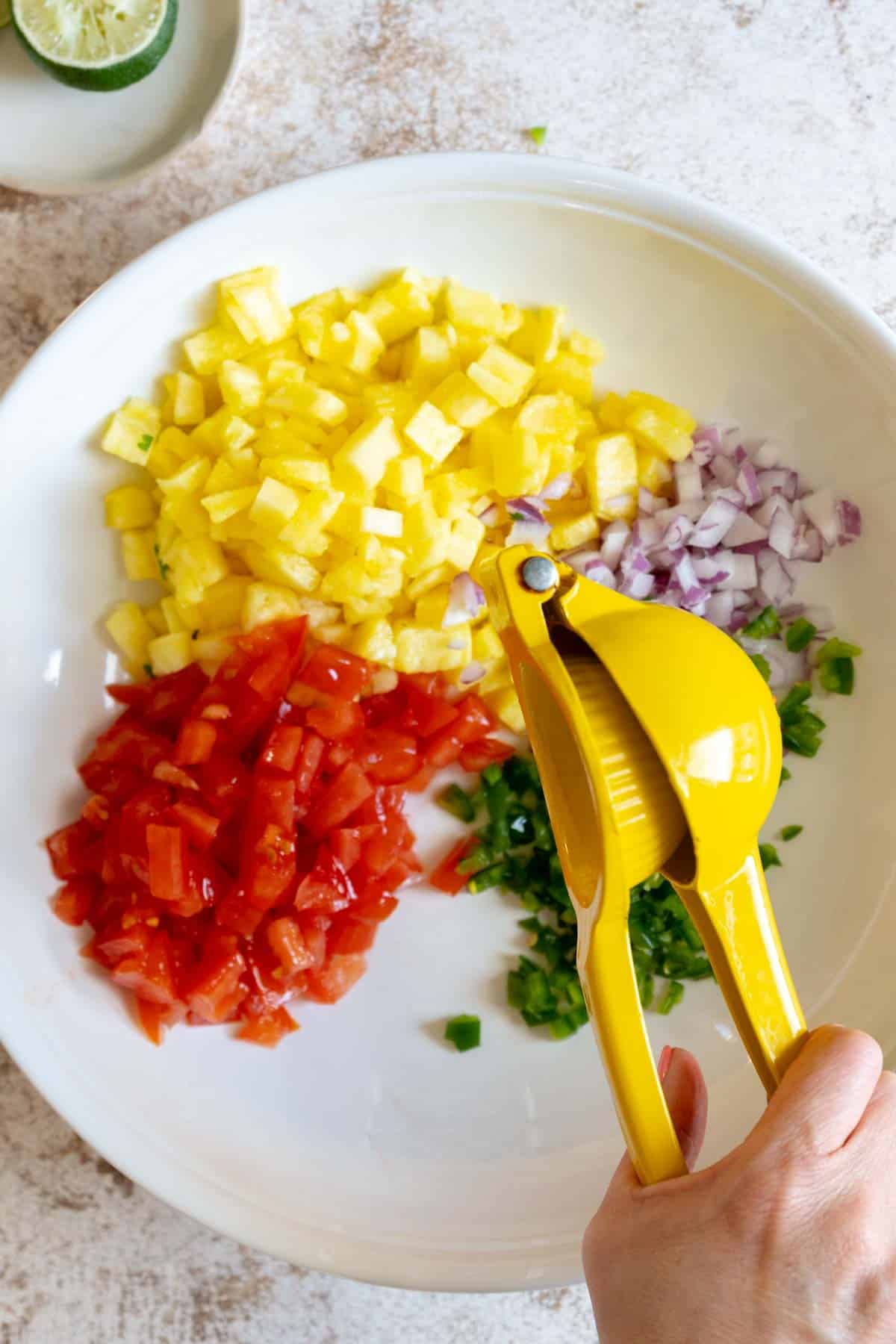 Squeezing lime over salsa.