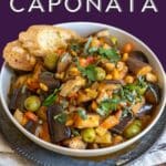 Caponata in a bowl with toasted bread.