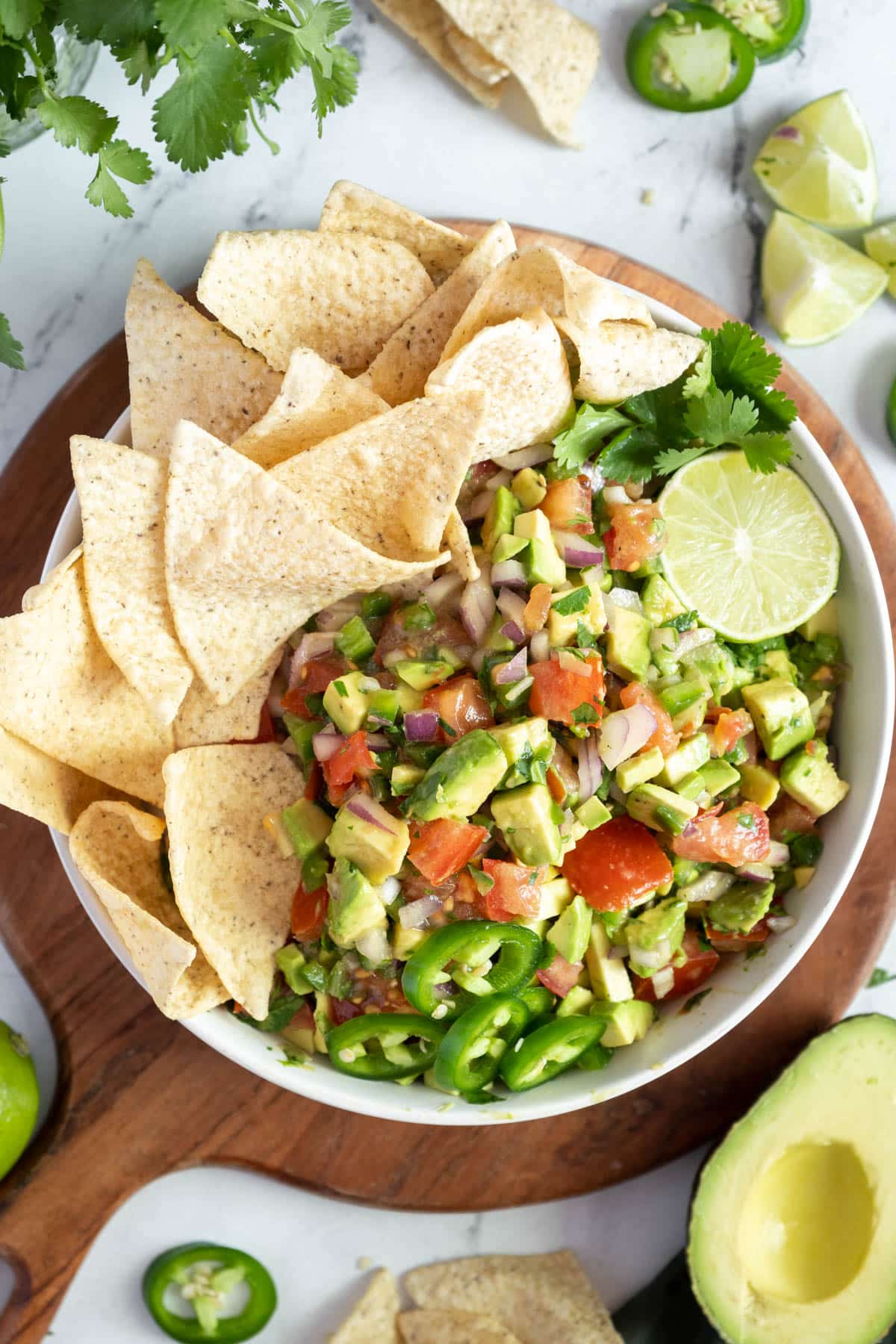 Avocado pico de gallo in a bowl with tortilla chips.