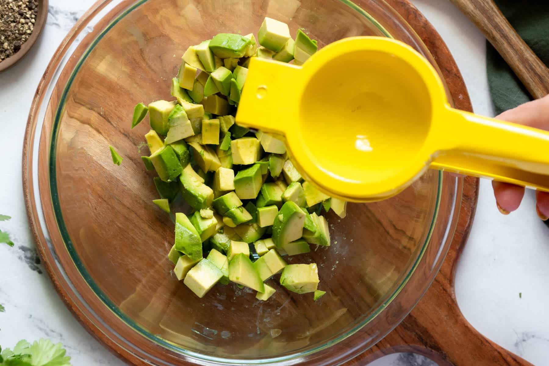 Adding lime to avocado.