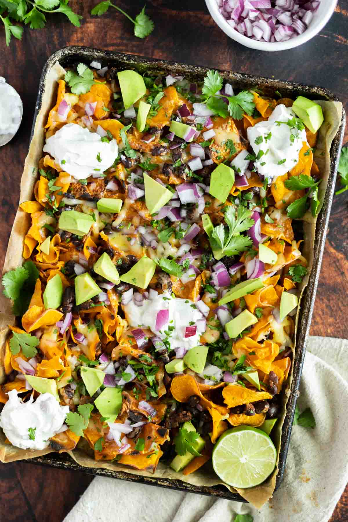 Nachos on a tray loaded with toppings.