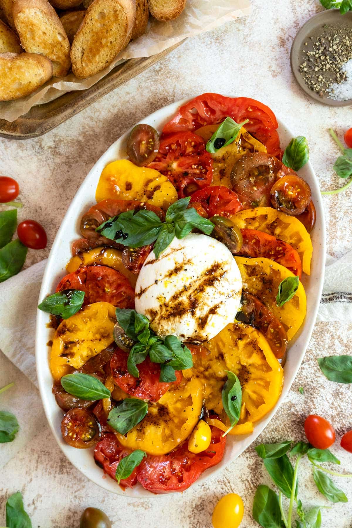 Burrata caprese salad on a platter.