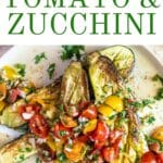 Roasted zucchini on a plate with tomatoes.