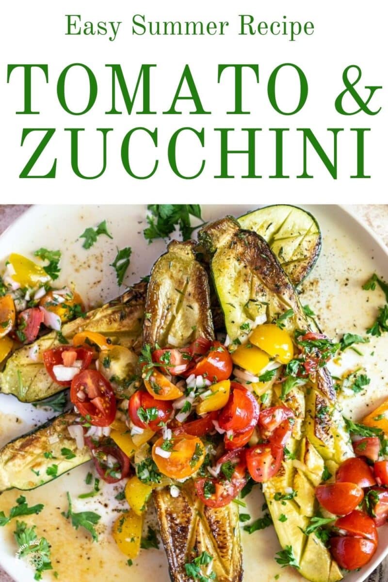Roasted zucchini on a plate with tomatoes.