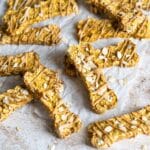 Homemade dog treats with rolled oats on parchment.