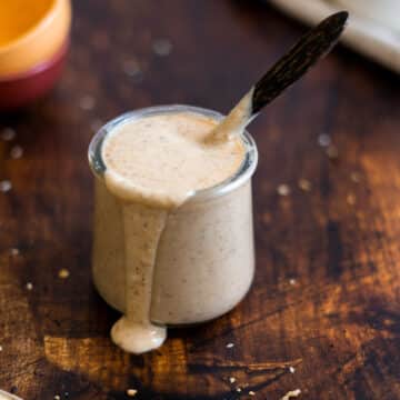 Honey mustard in a jar with a wooden spoon.