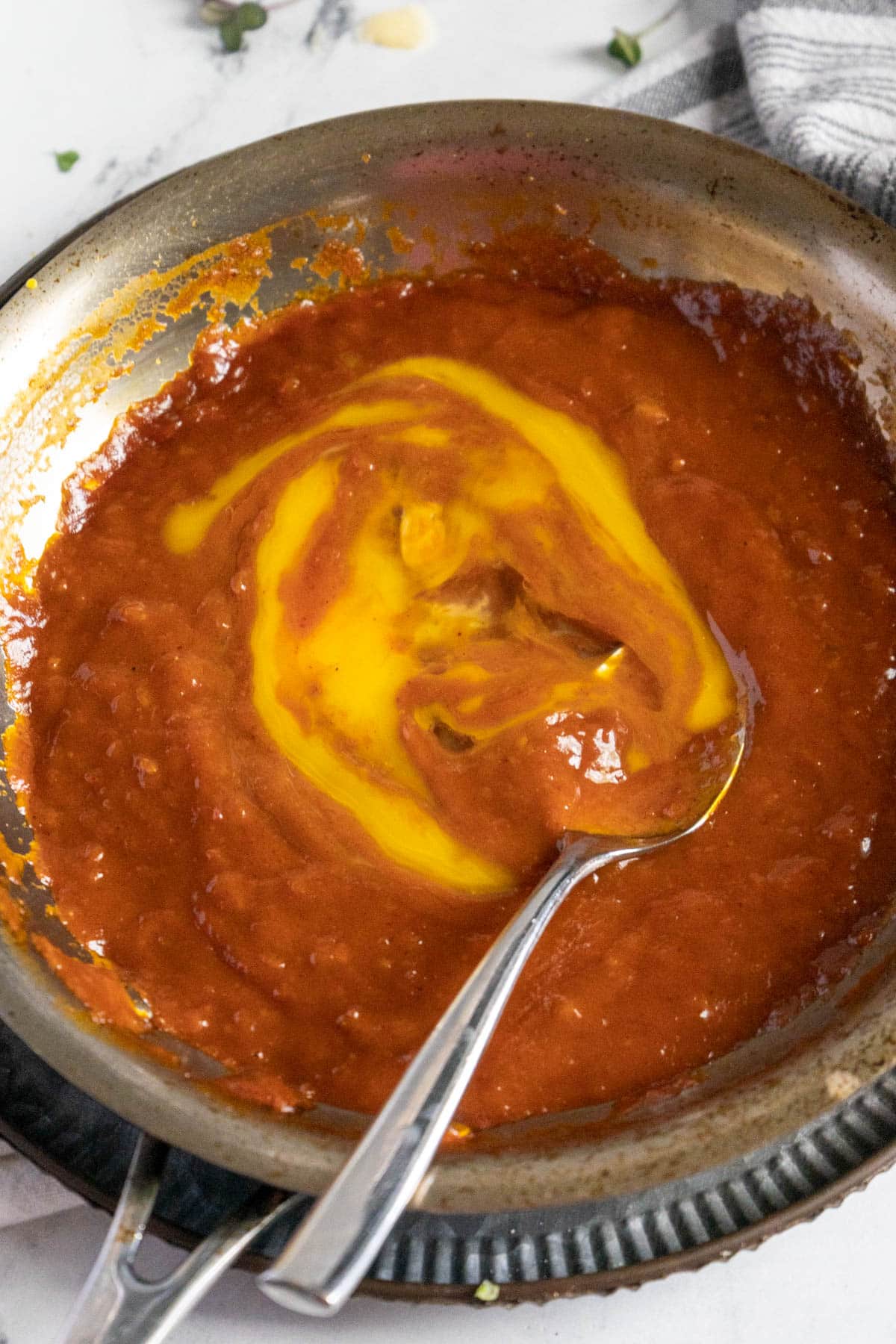 Adding egg yolks to BBQ sauce.