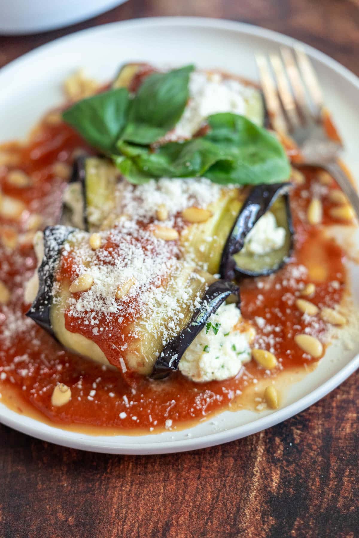 Eggplant rollatini on a plate with marinara.