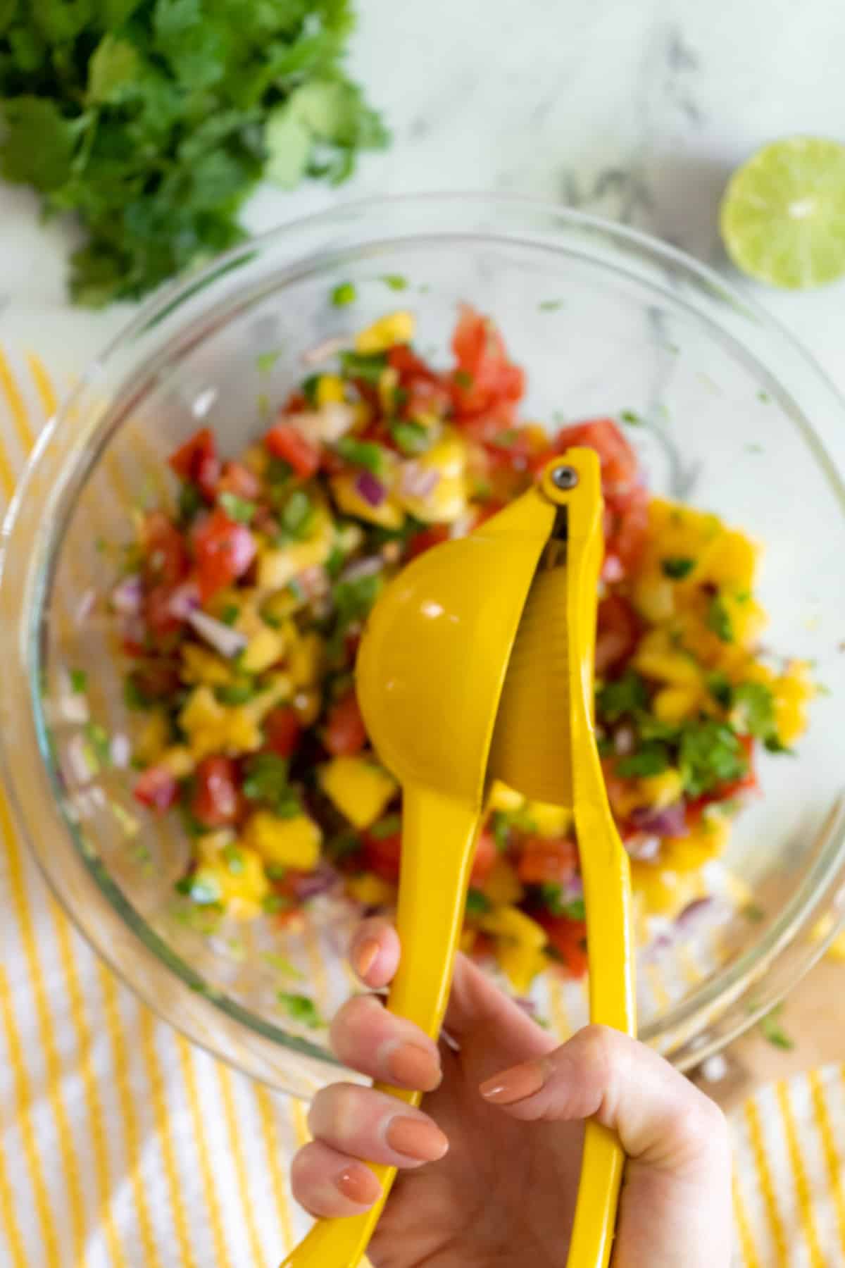 Squeezing lime into pico de gallo.