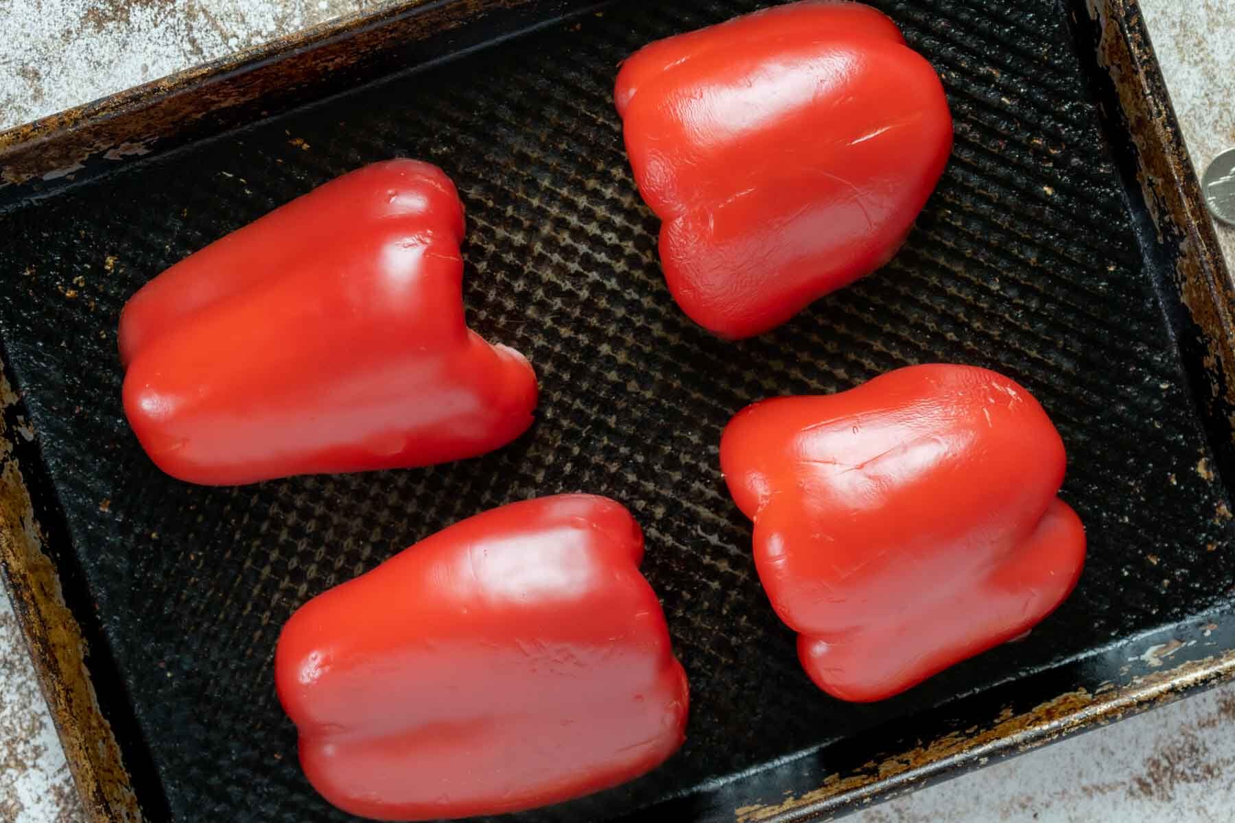 Cut red bell peppers on a baking sheet.