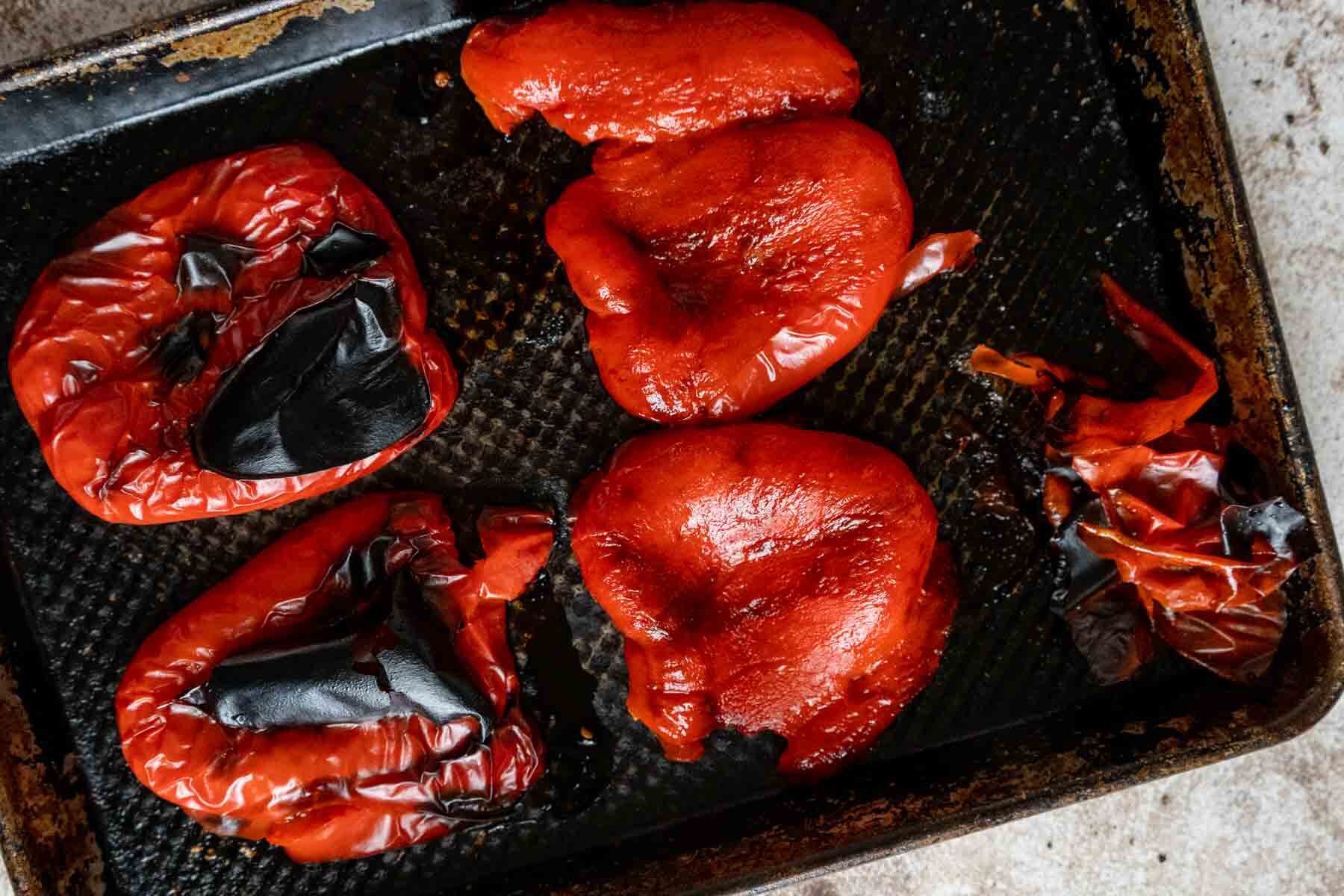 Roasted peppers on a baking sheet.