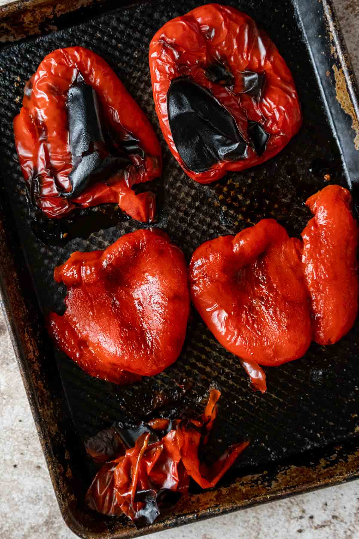 Roasted peppers on a baking sheet.