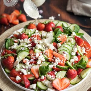 Poopy seed dressing on a cucumber and strawberry salad with mint and feta.
