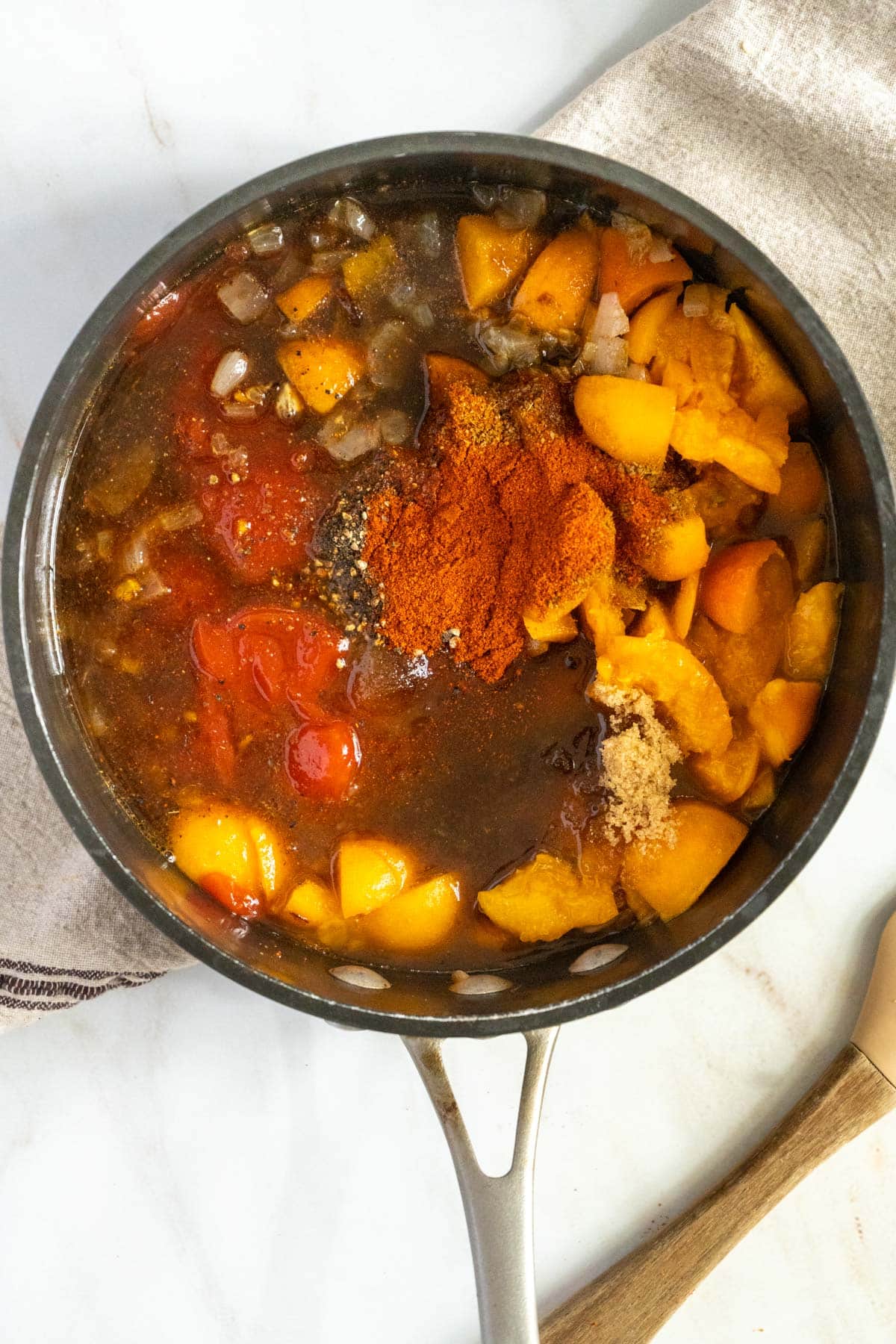 Cooking apricots down to make sauce.