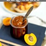 BBQ sauce in a jar with wooden spoon and sliced apricots.