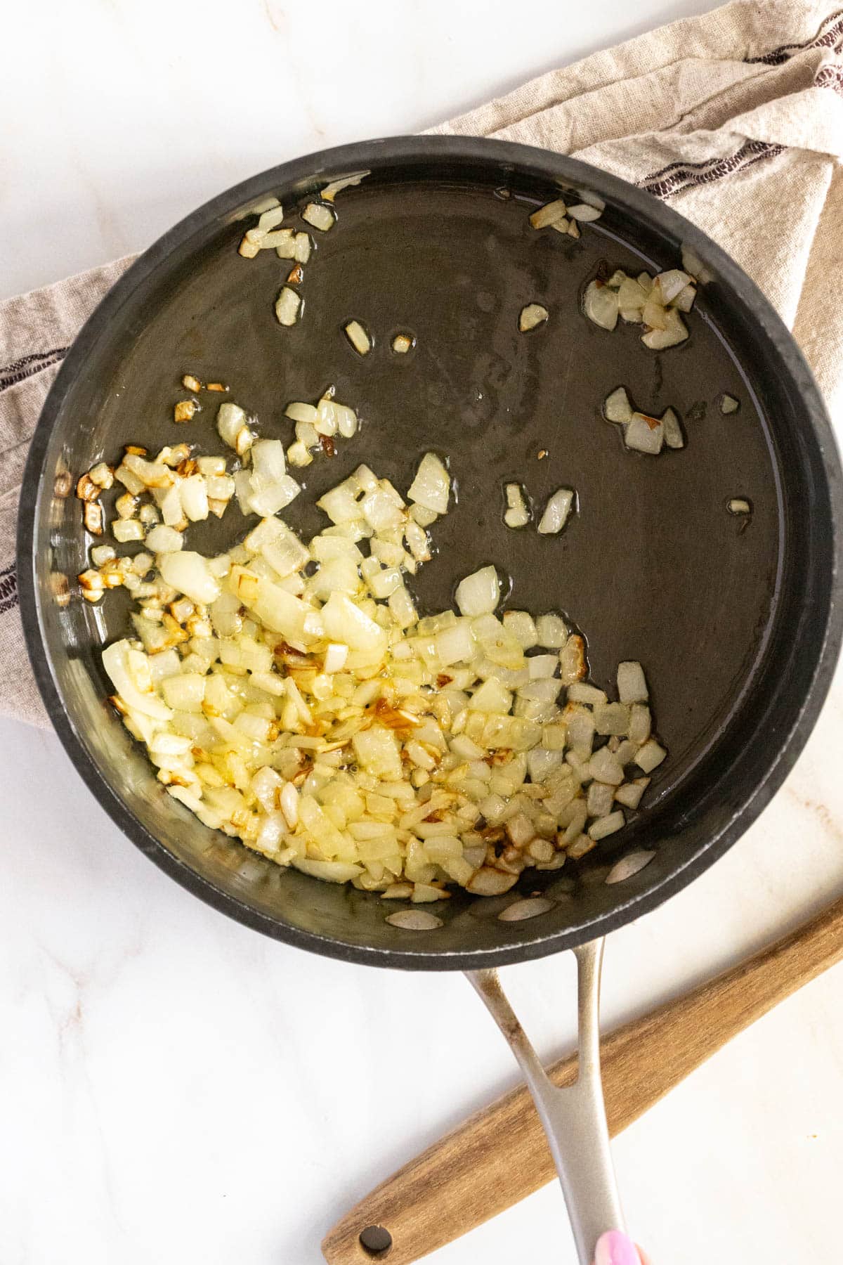 Sautéing onion in a pan.