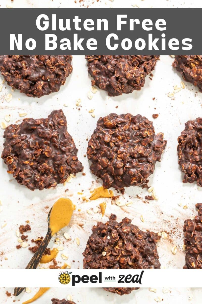 Gluten free no bake cookies on wax paper with a spoon of peanut butter.