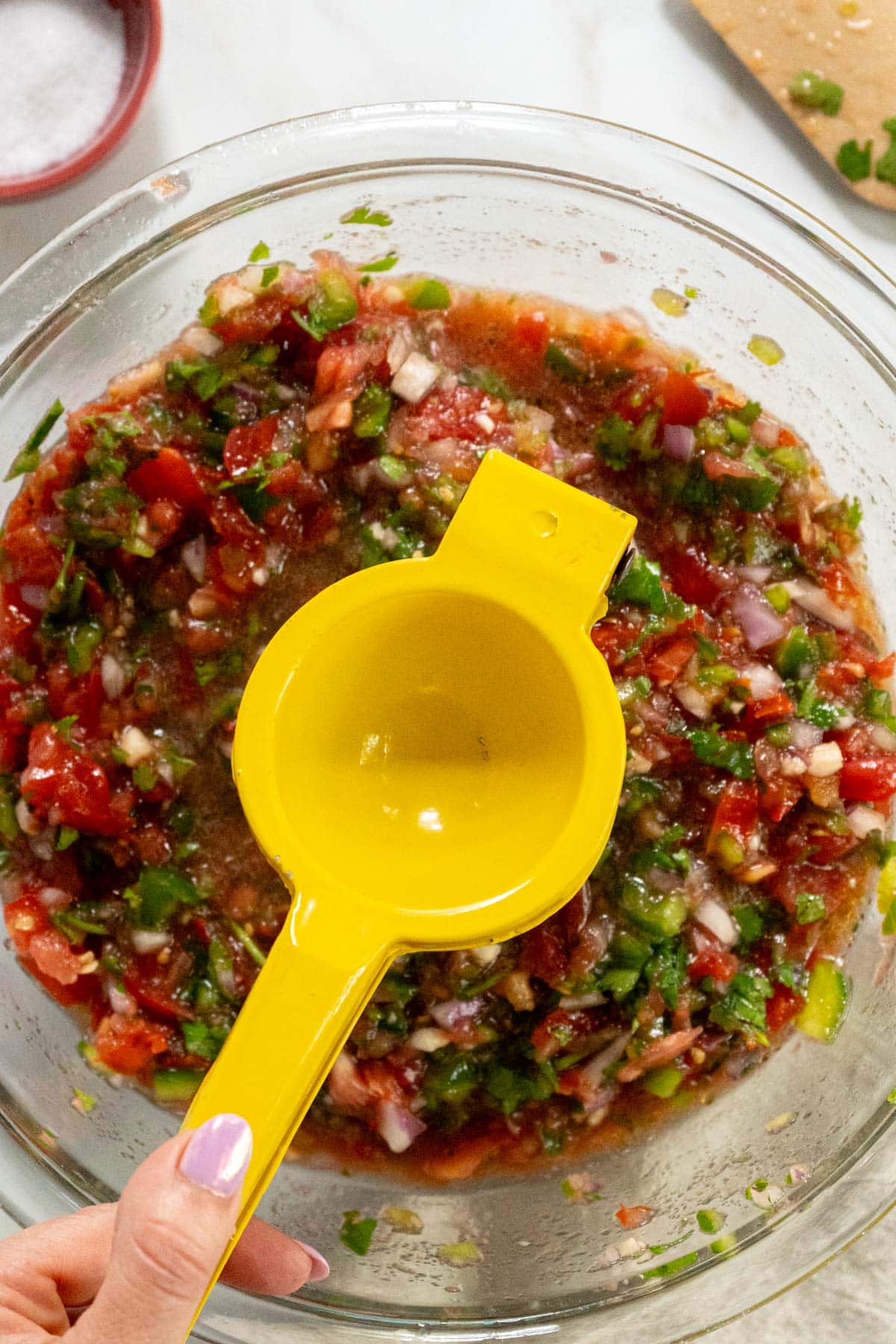 Squeezing fresh lime into the salsa.