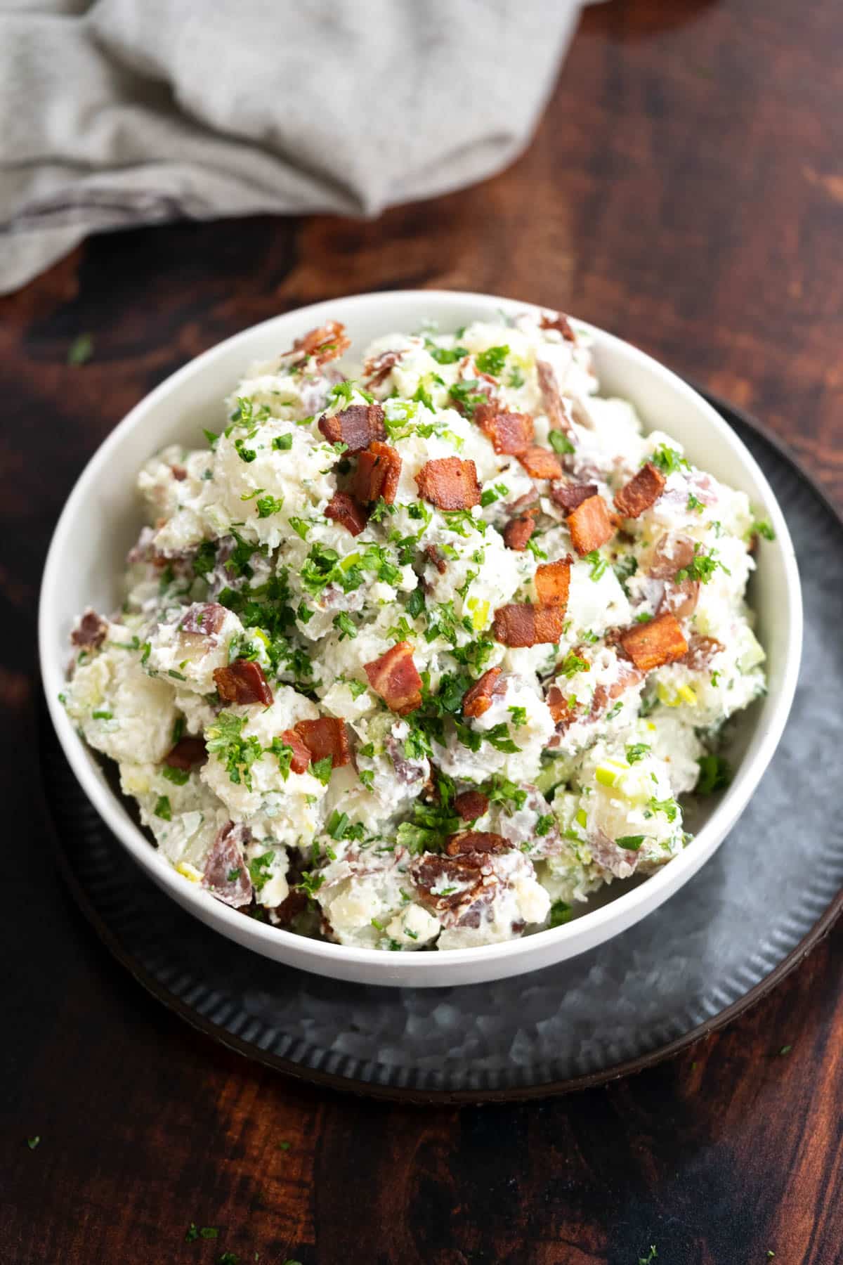 Blue cheese potato salad with bacon top.